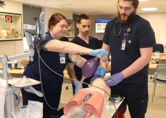 Respiratory therapy students at River Valley Community College in Claremont practice a medical simulation on Friday.