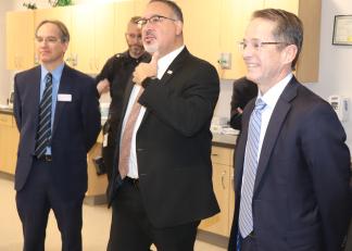 From left, River Valley Community College President Alfred Williams, U.S. Secretary of Education Miguel Cardona and New Hampshire Commissioner of Education Frank Edelblut speak with respiratory therapy students Friday at RVCC in Claremont. 