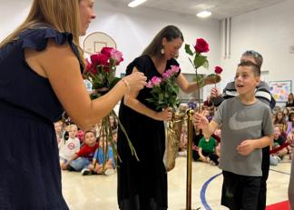 Teacher Liz Duclos receives a rose from a student. 