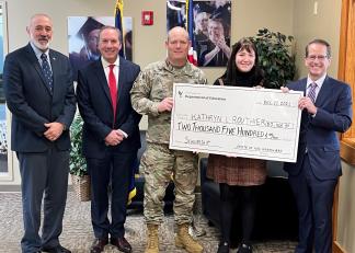 CAPTION: From left is Deputy Adjutant General Warren Perry, Stephen Appleby of NHDOE, Colonel Erik Fessenden of the New Hampshire National Guard, recipient Kathryn Routhier and Commissioner Frank Edelblut. 